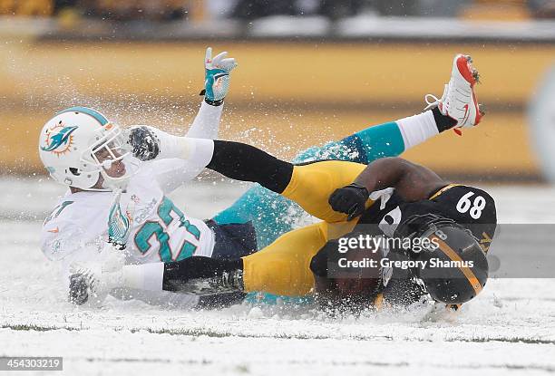 Jimmy Wilson of the Miami Dolphins tackles Jerricho Cotchery of the Pittsburgh Steelers in the second quarter at Heinz Field on December 8, 2013 in...