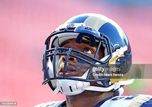 Defensive end Michael Sam of the St. Louis Rams looks up during pregame workouts before his team met the Miami Dolphins at Sun Life Stadium on August...