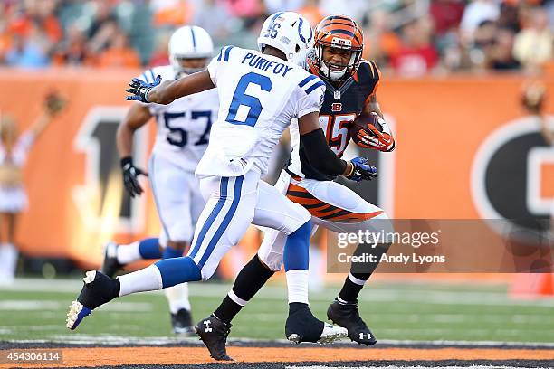 Colin Lockett of the Cincinnati Bengals attempts to run past Loucheiz Purifoy of the Indianapolis Colts during the first quarter at Paul Brown...