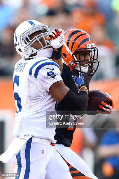 Colin Lockett of the Cincinnati Bengals grabs hold of the face mask of Loucheiz Purifoy of the Indianapolis Colts while attempting to break a tackle...