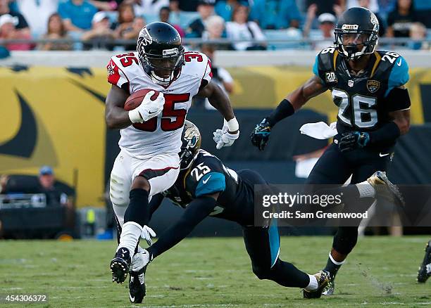 Sherrod Martin of the Jacksonville Jaguars attempts to tackle Antone Smith of the Atlanta Falcons during the preseason NFL game at EverBank Field on...