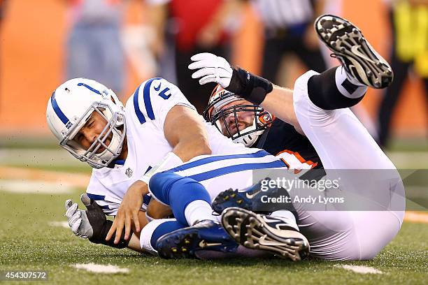 Chandler Harnish of the Indianapolis Colts is sacked by Margus Hunt of the Cincinnati Bengals during the second quarter at Paul Brown Stadium on...