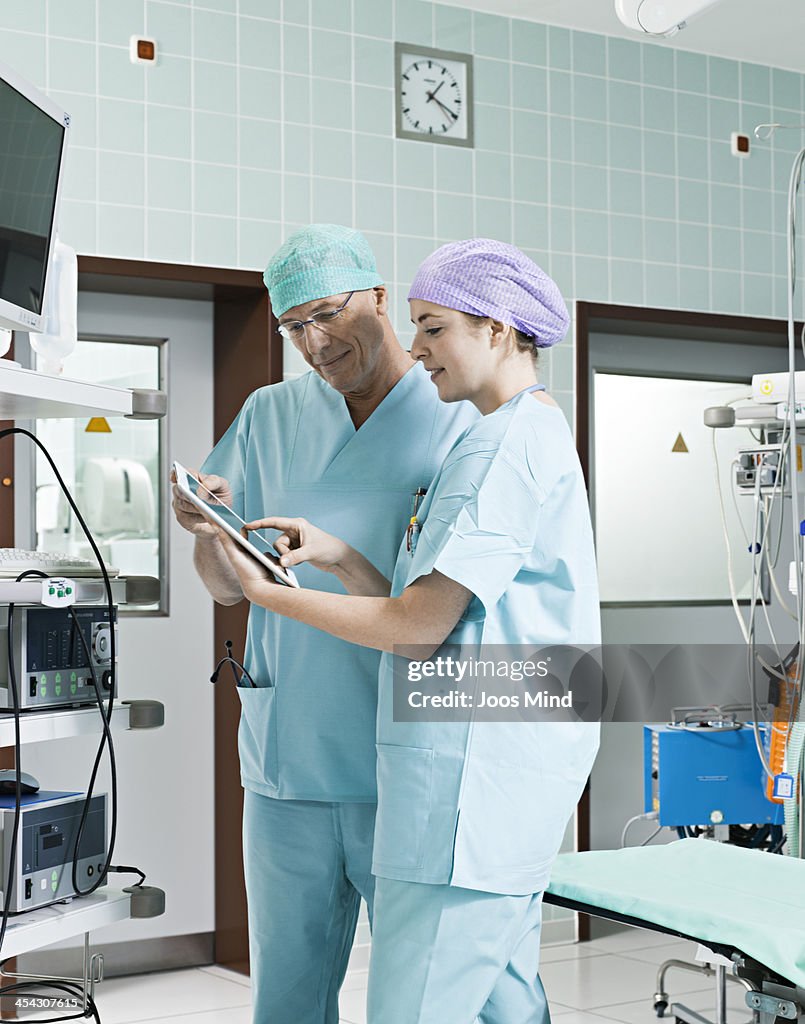 Surgeons using digital tablet