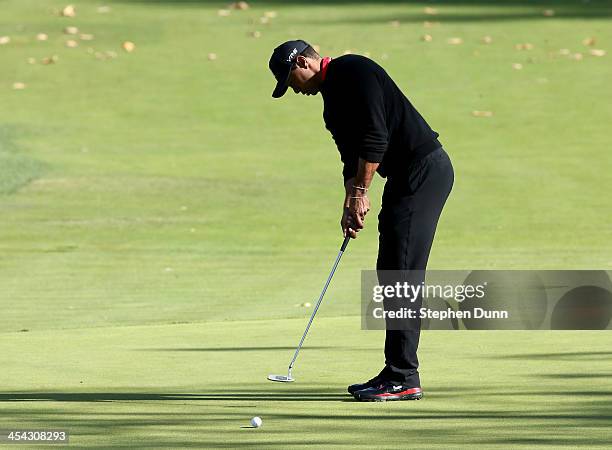 Tiger Woods putts on the fourth hole during the final round of the Northwestern Mutual World Challenge at Sherwood Country Club on December 8, 2013...