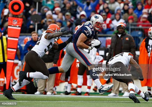 Rob Gronkowski of the New England Patriots catches a pass before being hit by T.J. Ward of the Cleveland Browns in the third quarter during the game...