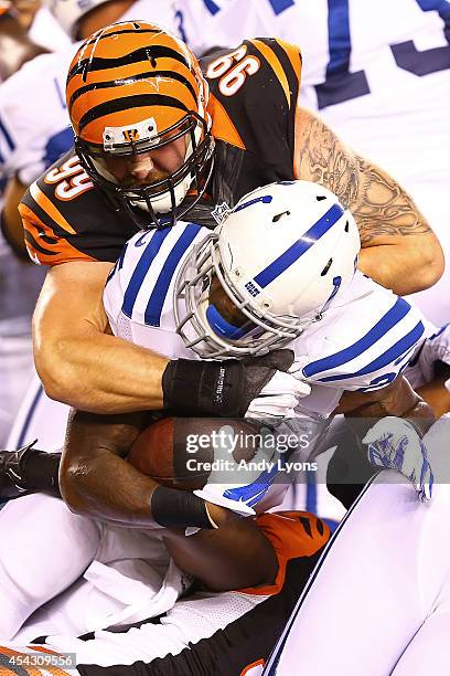 Margus Hunt of the Cincinnati Bengals tackles David Fuellen of the Indianapolis Colts for a loss during the third quarter at Paul Brown Stadium on...