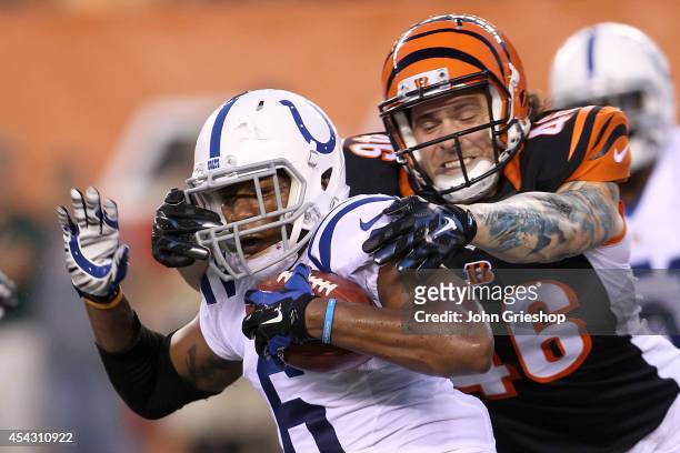 Clark Harris of the Cincinnati Bengals tackles Loucheiz Purifoy of the Indianapolis Colts during the third quarter at Paul Brown Stadium on August...
