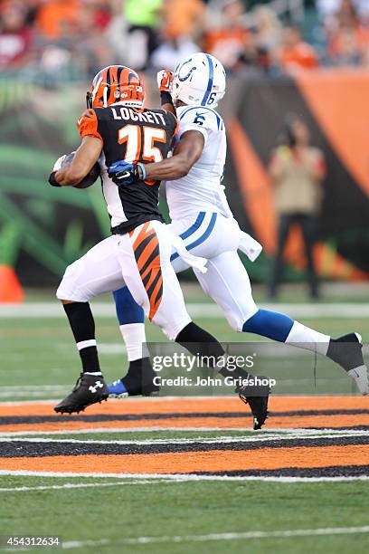 Colin Lockett of the Cincinnati Bengals grabs the face mask of Loucheiz Purifoy of the Indianapolis Colts while trying to break a tackle during the...