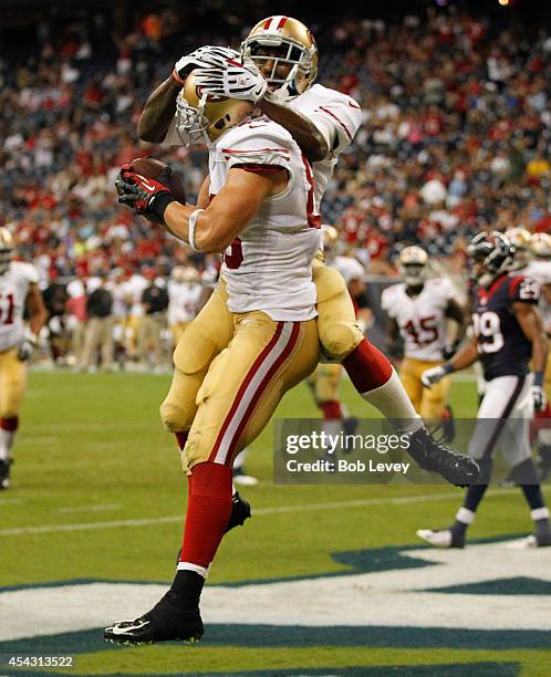 Kyle Nelson of the San Francisco 49ers celebrates with Lance Lewis after scoring on a two yard pass in the fourth quarter against the Houston Texans...