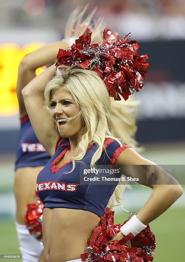 A Houston Texans cheerleader performs during a timeout between the ...