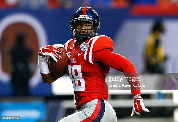 Cody Core of the Mississippi Rebels takes a reception in for a touchdown against the Boise State Broncos at Georgia Dome on August 28, 2014 in...