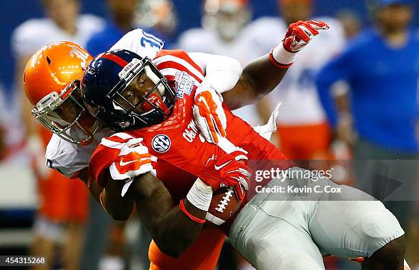 Jonathan Moxey of the Boise State Broncos tackles Laquon Treadwell of the Mississippi Rebels at Georgia Dome on August 28, 2014 in Atlanta, Georgia.