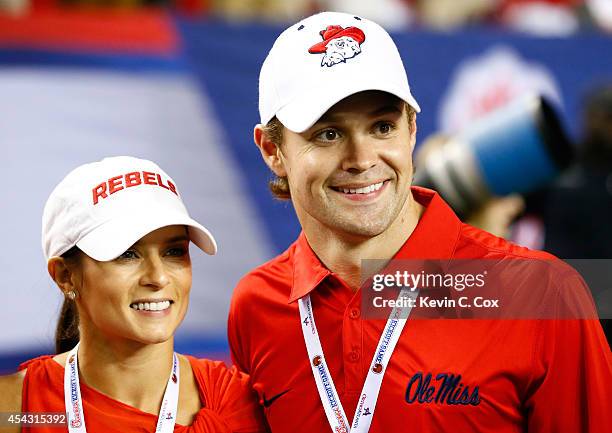 Sprint Cup drivers Danica Patrick and Ricky Stenhouse Jr. Pose for pictures during the game between the Mississippi Rebels and the Boise State...