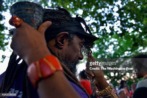 William H. Taft, who has been the permit holder for the Meridian Hill Park drum circle for the past 20 years, receives blessings with frankincense...