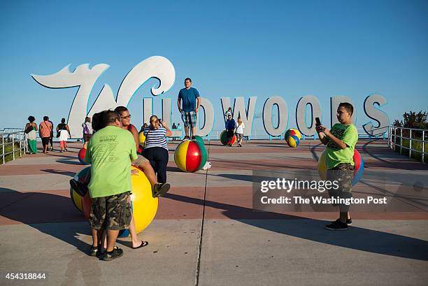 Tourists take photos in front of the Wildwood sign at the Boardwalk on Sunday, August 24, 2014 in Wildwood, NJ.