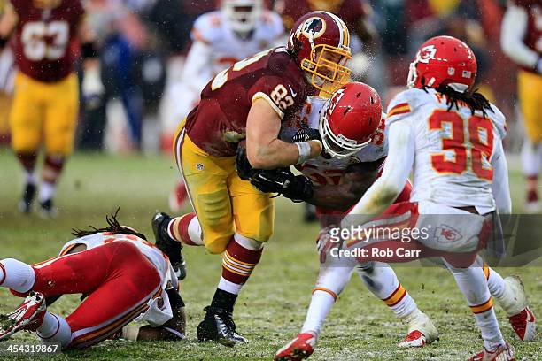 Tight end Logan Paulsen of the Washington Redskins has the ball knocked loose by linebacker James-Michael Johnson of the Kansas City Chiefs after...