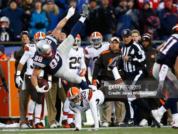 Matthew Mulligan of the New England Patriots leaps over Joe Haden of the Cleveland Browns after catching a pass in the fourth quarter during the game...