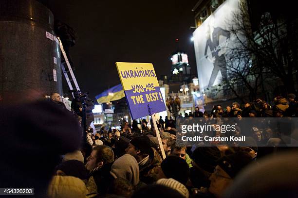 Protesters gather around a pulled down satue of Lenin at a monument on December 8, 2013 in Kiev, Ukraine. The statue of Lenin wars pulled down after...