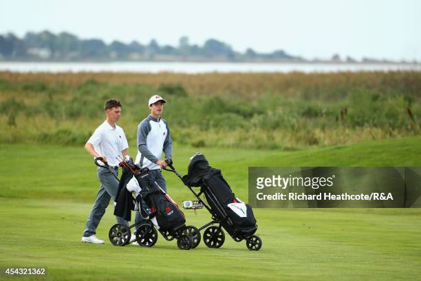 Tim Harry and Rowan Lester of GB&I walk down the 9th fairway during their match against Adam Blomme and Marcus Kinhult of Europe at the first day of...