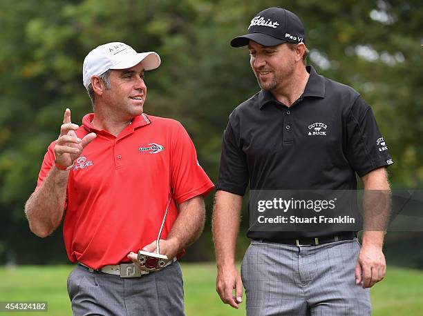 Hennie Otto of South Africa talks with counrtman Darren Fichardt during the second round of the 71st Italian Open Damiani at Circolo Golf Torino on...