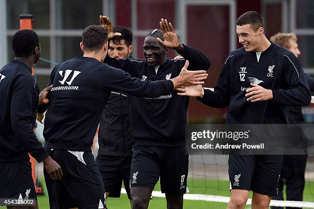 Mamadou Sakho, Emre Can and Lloyd Jones of Liverpool celebrating after a training session at at Melwood Training Ground on August 29, 2014 in...