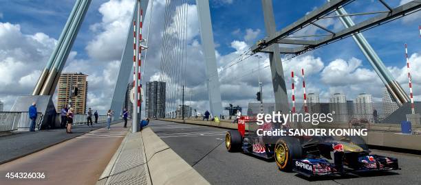 Scuderia Toro Rosso's Dutch driver Max Verstappen drives an F1 car on the Erasmus Bridge in Rotterdam, The Netherlands, on August 29 to promote the...