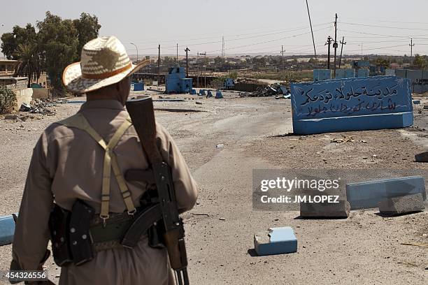 Member of the Kurdish Peshmerga forces looks at positions of Islamic State fighters in the eastern town of Jalawla, 130 kilometres northeast of...