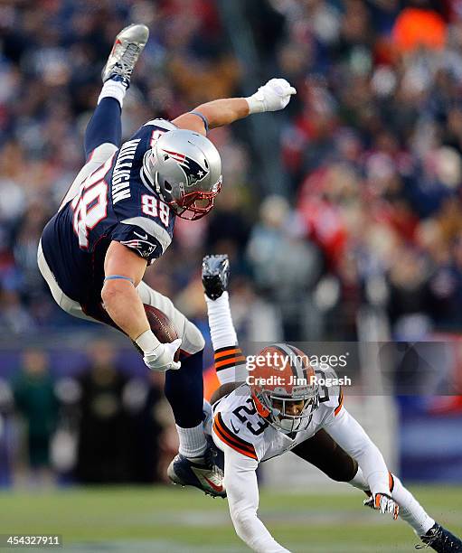 Matthew Mulligan of the New England Patriots leaps over Joe Haden of the Cleveland Browns to gain yards in the 4th quarter at Gillette Stadium on...
