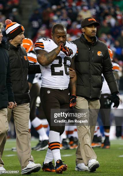 Willis McGahee of the Cleveland Browns leaves the field with an injury against the New England Patriots at Gillette Stadium on December 8, 2013 in...