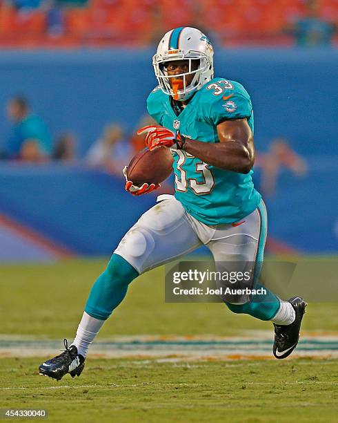 Daniel Thomas of the Miami Dolphins runs with the ball during first quarter action against the St. Louis Rams during a preseason game on August 28,...