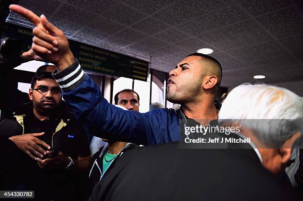 Abdull Oun from Glasgow, voices his opinions on the recent conflicts in Iraq and Palestine to Better Together leader Alistair Darling during a visit...