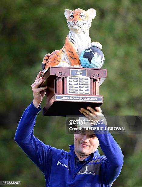 Golfer Zach Johnson lifts the championship trophy after the final round of play to win the Northwestern Mutual World Challenge golf tournament at the...