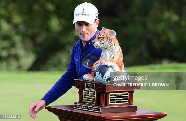 Golfer Zach Johnson eyes the championship trophy after the final round of play to win the Northwestern Mutual World Challenge golf tournament at the...