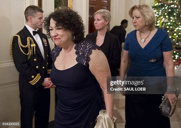 Supreme Court Justice Sonia Sotomayor arrives for a reception for Kennedy Center honorees hosted by US President Barack Obama in the East Room of the...