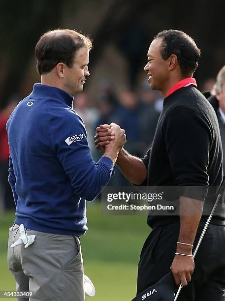 Zach Johnson and Tiger Woods shake hands after Johnson defeated Woods on the first playoff hole during the final round of the Northwestern Mutual...