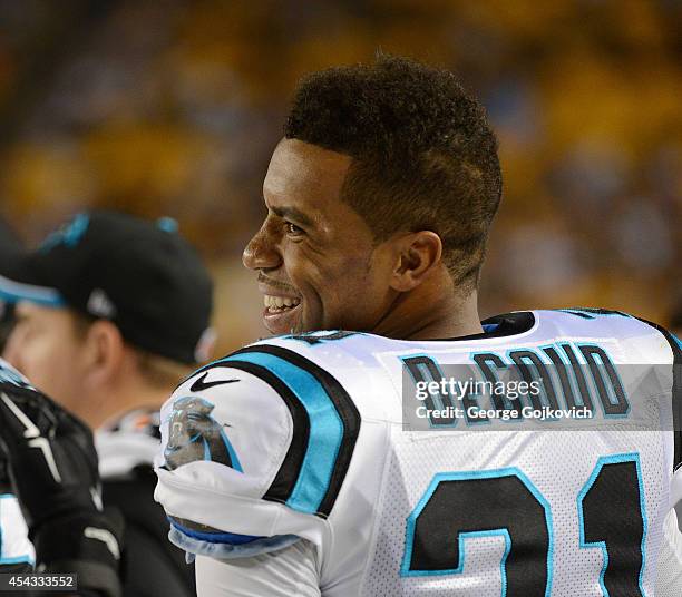 Safety Thomas DeCoud of the Carolina Panthers smiles as he looks on from the sideline during a preseason game against the Pittsburgh Steelers at...