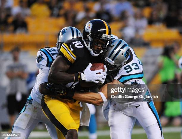 Wide receiver Martavis Bryant of the Pittsburgh Steelers is tackled by safety Thomas DeCoud and linebacker Chase Blackburn of the Carolina Panthers...