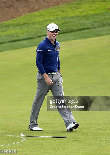 Zach Johnson reacts after holing out from the drop zone after going in the water on the 18th hole to force a playoff during the final round of the...