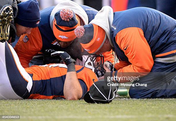 Denver Broncos wide receiver Eric Decker gets looked at on the field after being hit by Tennessee Titans strong safety Bernard Pollard during the...