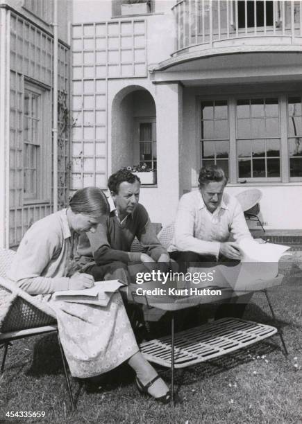 Imogen Holst , fellow composer and conductor Benjamin Britten and tenor Peter Pears discussing Britten's opera 'Billy Budd' in a garden at Aldeburgh,...