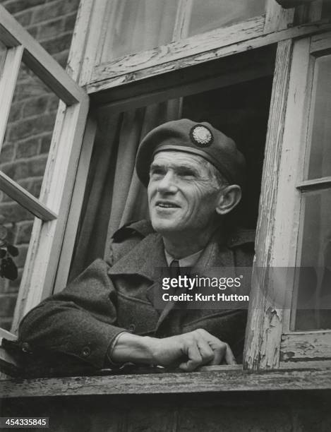 German-born photographer Kurt Hutton in Press Corps uniform at his home in Hampstead Garden Suburb, London, 1946. Hutton first worked for the Dephot...