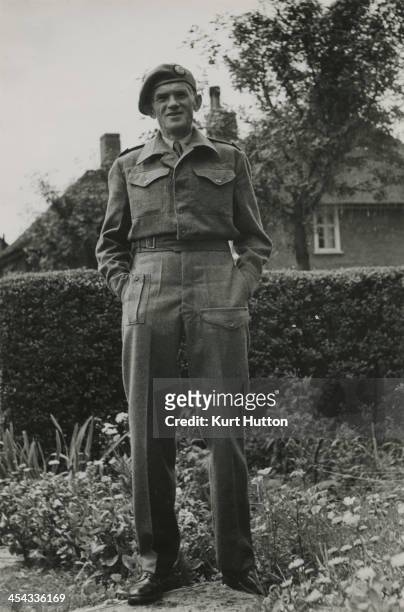German-born photographer Kurt Hutton in Press Corps uniform at his home in Hampstead Garden Suburb, London, circa 1945. Hutton first worked for the...
