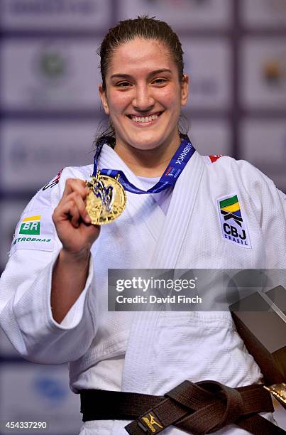 Under 78kg gold medallist, Mayra Aguiar of Brazil smiles and proudly shows her gold medal tinted with meteorite pieces during the Chelyabinsk Judo...