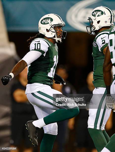 Clyde Gates of the New York Jets celebrates his touchdown catch with quarterback Tajh Boyd during a preseason football game against the Philadelphia...