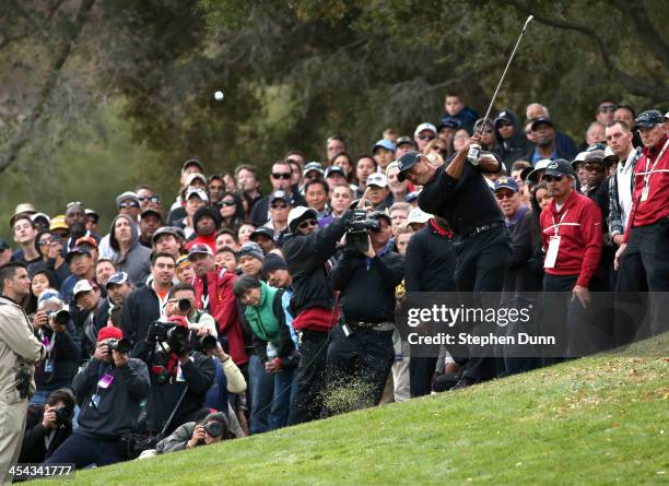 Tiger Woods hits from the rough on the 18th hole during the final round of the Northwestern Mutual World Challenge at Sherwood Country Club on...