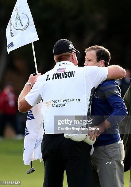 Zach Johnson hugs caddie Damon Green after Johnson won on the first playoff hole during the final round of the Northwestern Mutual World Challenge at...