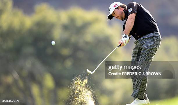 Northern Ireland's Graeme McDowell plays a shot to the green at the 18th hole during the final round of play at the Northwestern Mutual World...