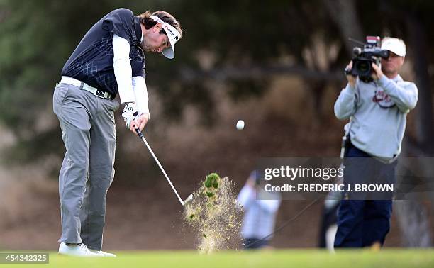 Golfer Bubba Watson plays a shot to the green at the 18th hole during the final round of play at the Northwestern Mutual World Challenge golf...