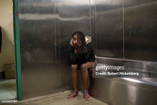 Woman breaks down after being searched in a holding room February 2, 2013 by vice squad police with the Los Angeles Police Department of South...