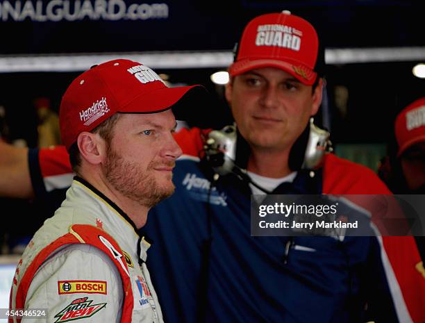 Dale Earnhardt Jr., driver of the National Guard Chevrolet, stands in the garage area with his crew chief Steve Letarte during practice for the...